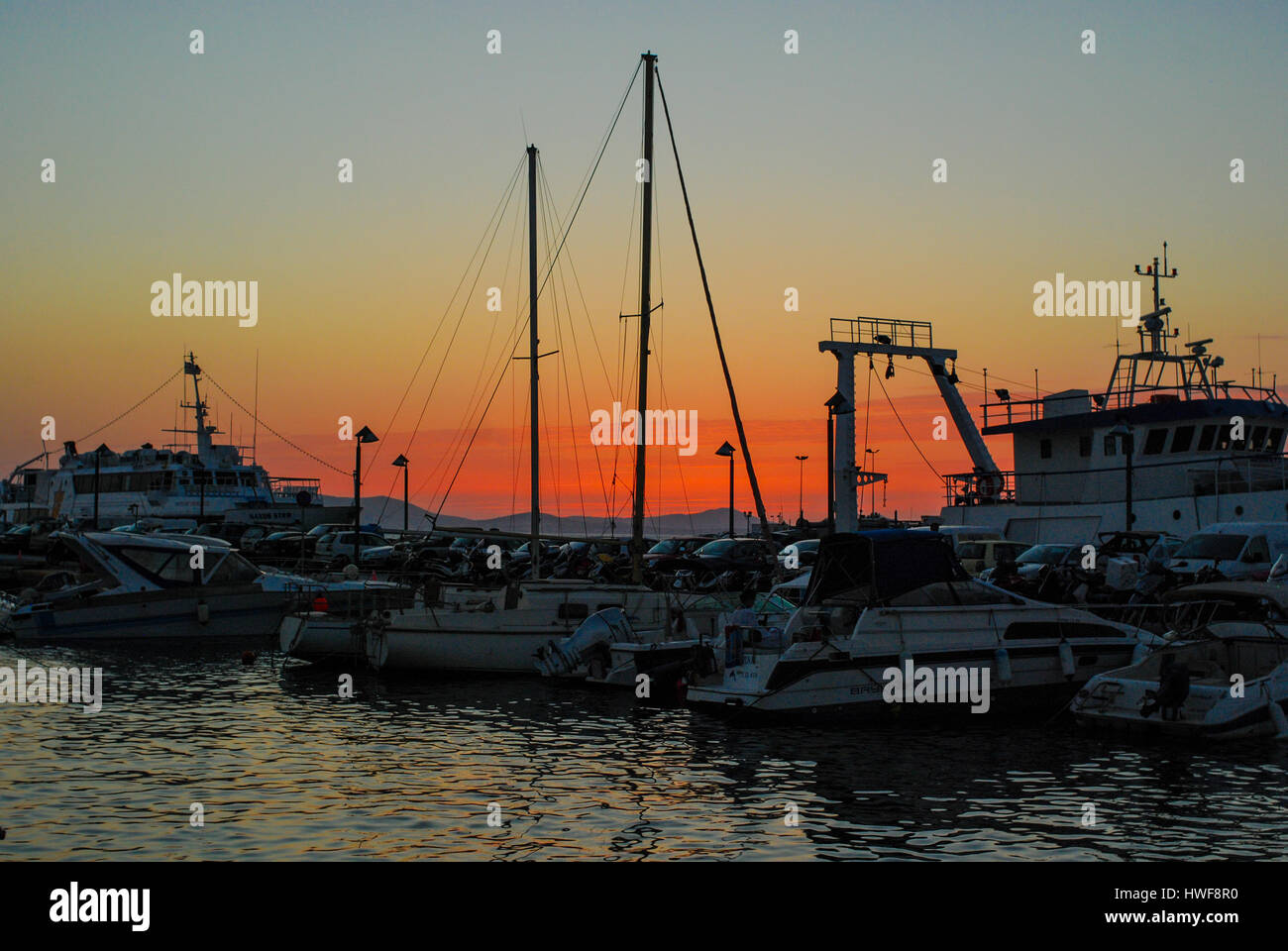 Sunset over the port at Naxos in the Greek Cyclades Islands. Stock Photo