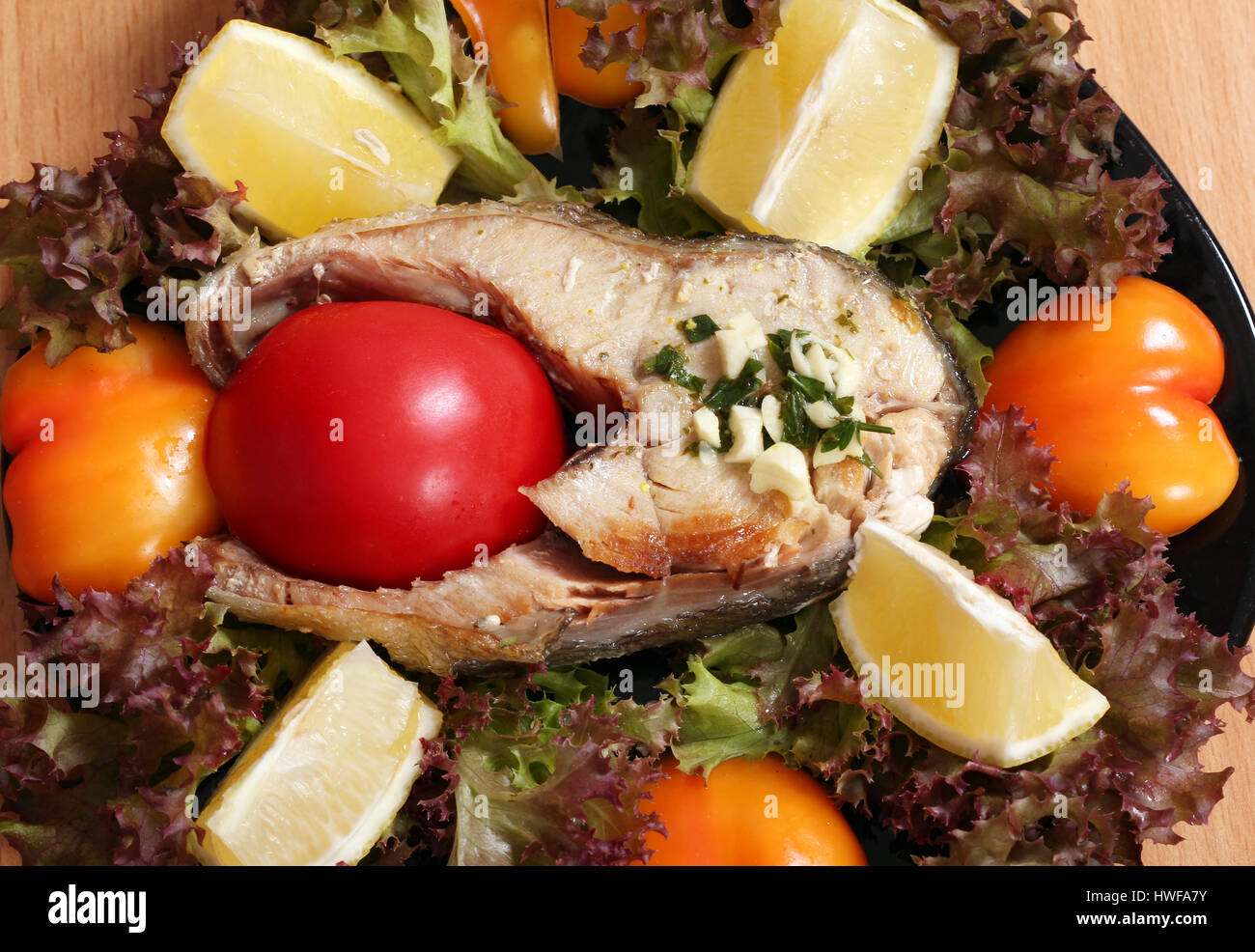 seafood salmon with tomato lemon and salad Stock Photo