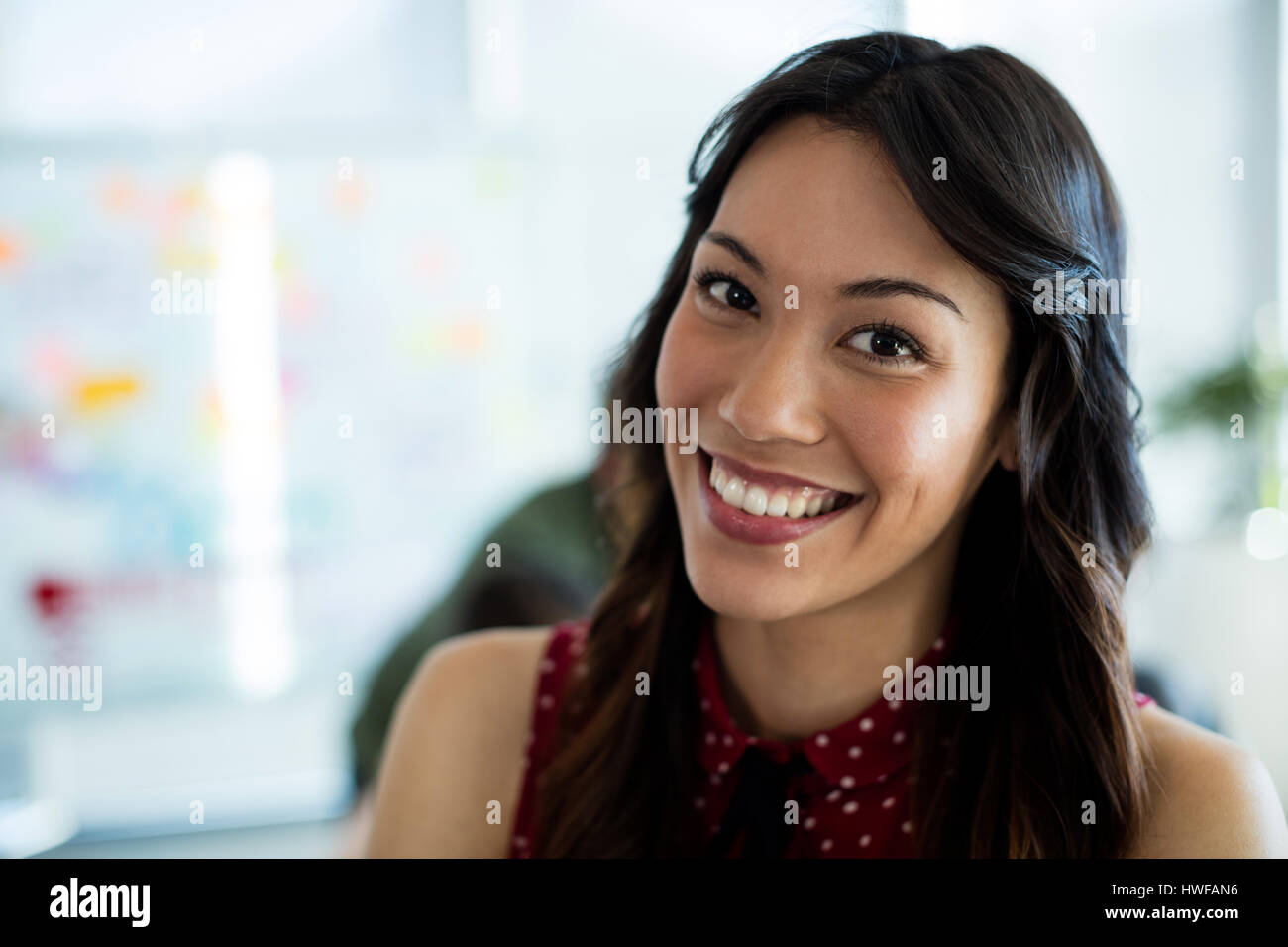 Portrait of smiling woman in office Stock Photo - Alamy