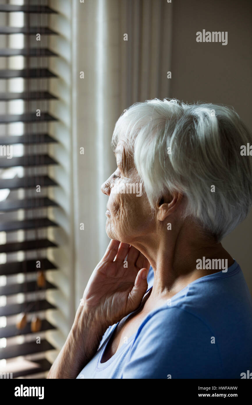 Woman looking out window and home hi-res stock photography and images ...