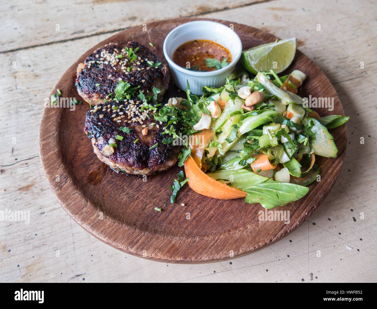 Spicy lamb meat patties, burgers with a cashew nut and green salad