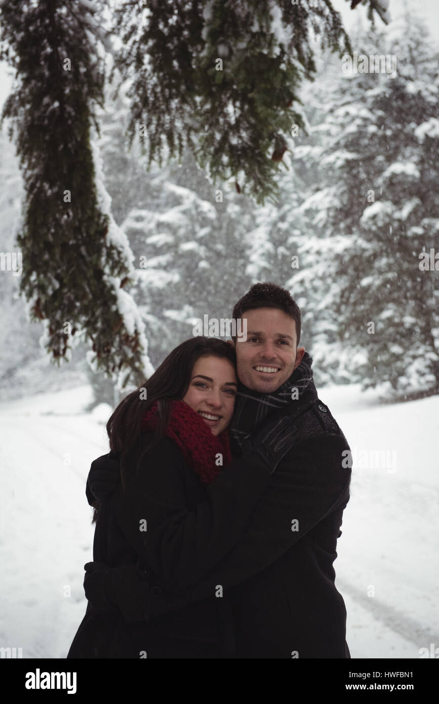 Romantic couple embracing in forest during winter Stock Photo - Alamy