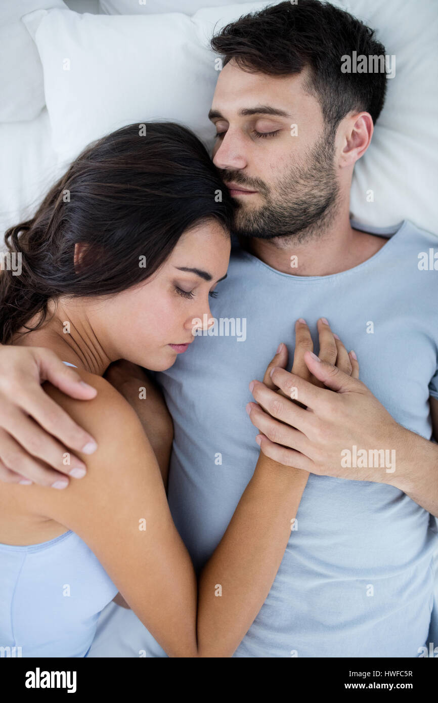 Young Romantic Couple Sleeping On Beda A In Bedroom Stock