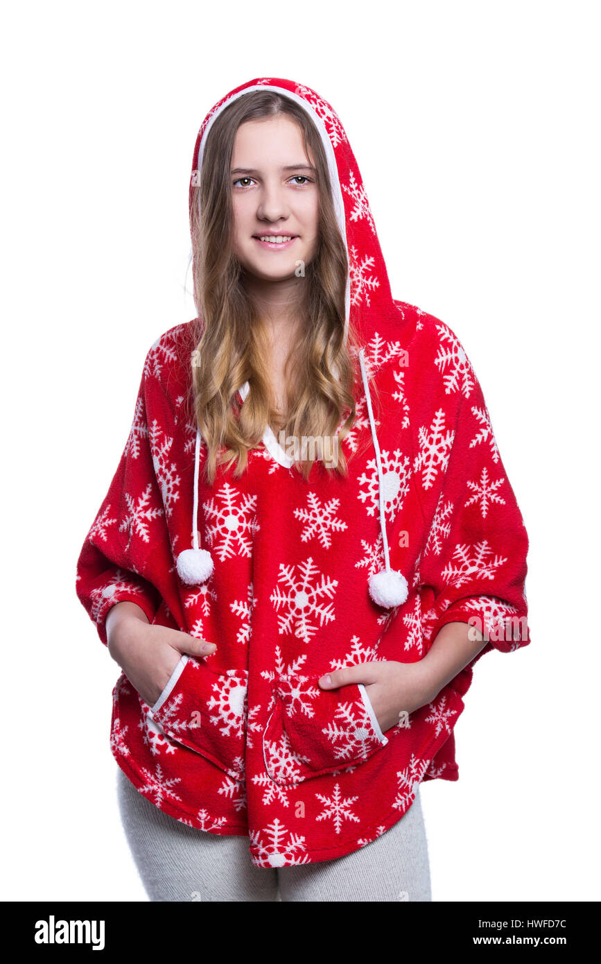 Lovely cheerful teenage girl posing in the studio. Wearing red winter hoodie with snowflakes. Isolated on white background. Winter clothes Stock Photo