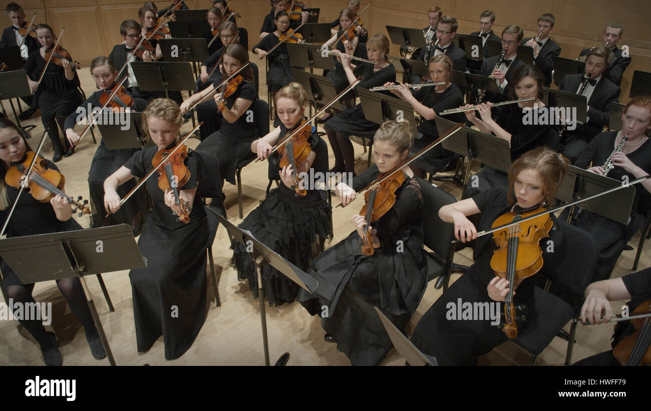 High angle view of student musicians playing violins in orchestra recital Stock Photo