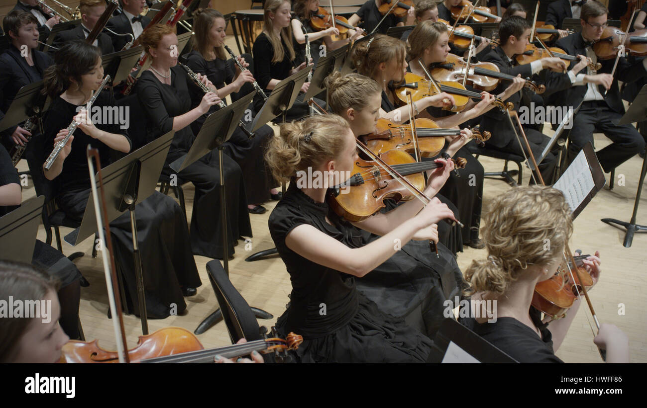 High angle view of student musicians playing instruments in orchestra recital Stock Photo