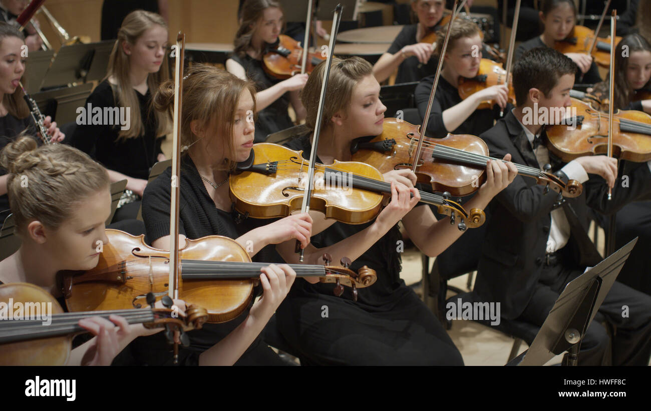 High angle view of student musicians playing violins in orchestra