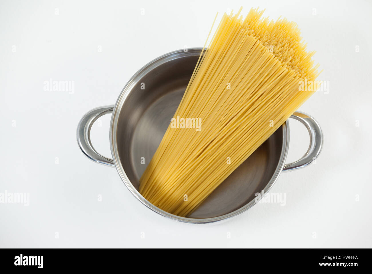 Spaghetti pasta in utensil on white background Stock Photo Alamy