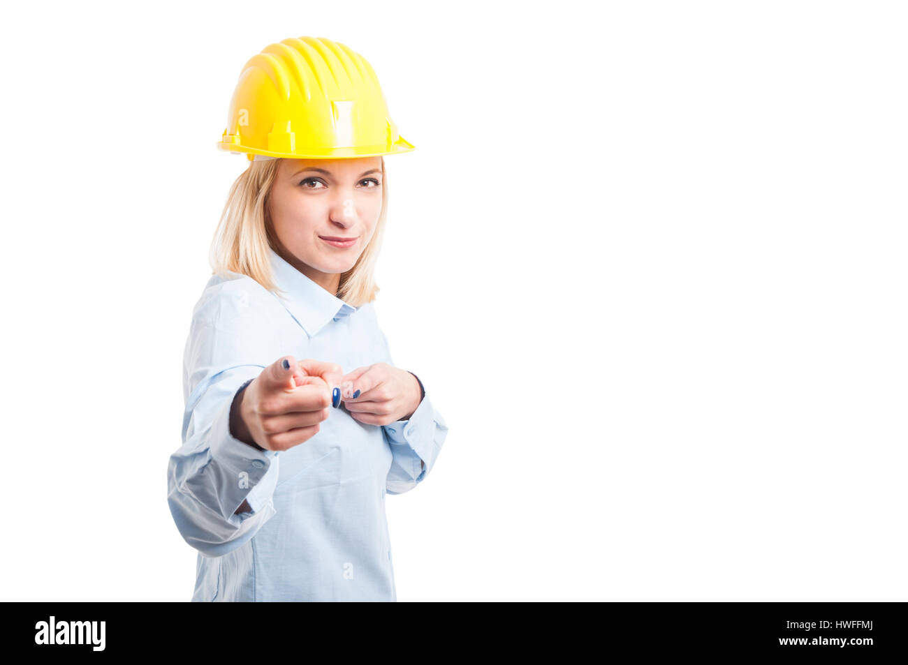 Lady engineer wearing yellow posing and pointing at camera isolated on ...