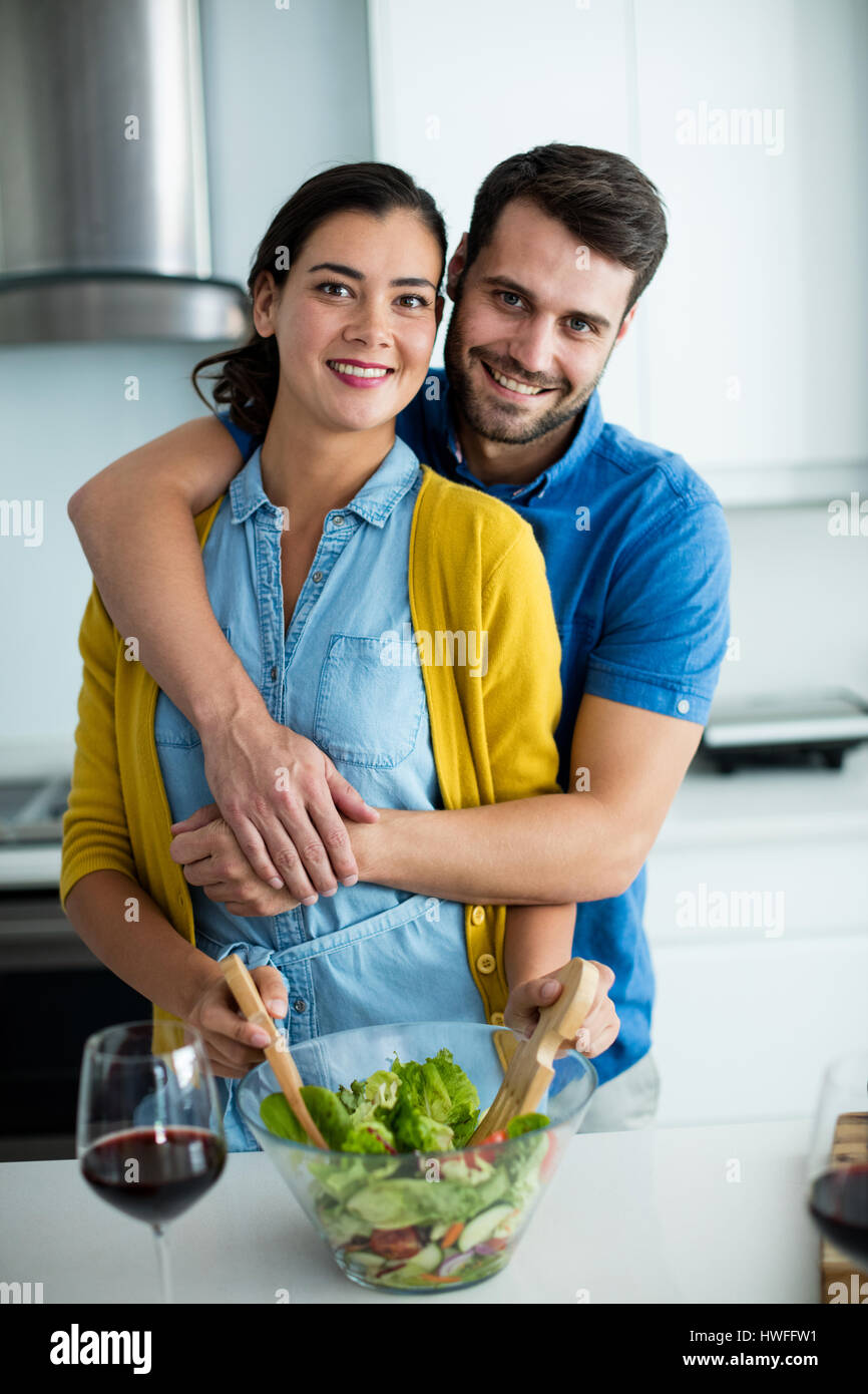 Portrait of man embracing woman in the kitchen at home Stock Photo - Alamy
