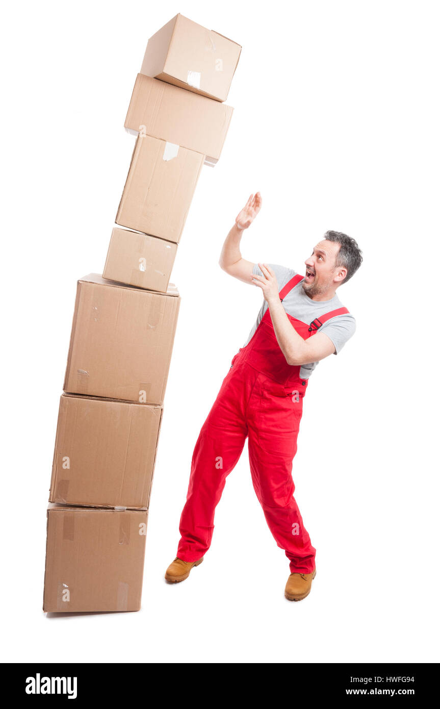 Bunch of big cardboard boxes falling over mover guy acting scared isolated on white background Stock Photo