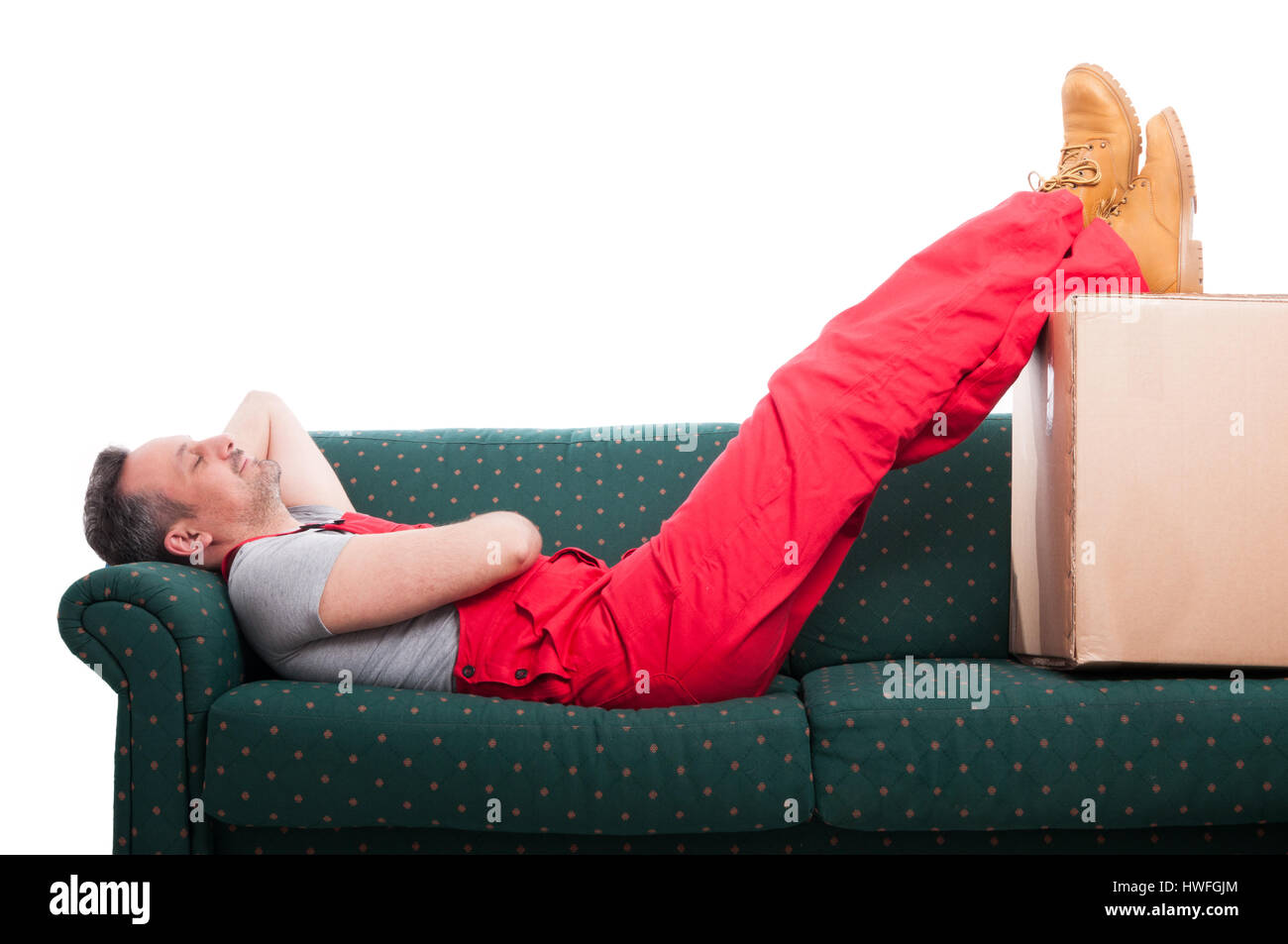 Mover man resting laid down on couch with feet up isolated on white