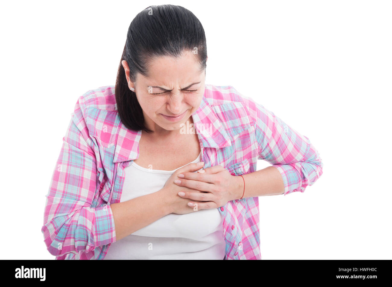 Woman having severe chest pain as heart attack and illness concept isolated on white background Stock Photo