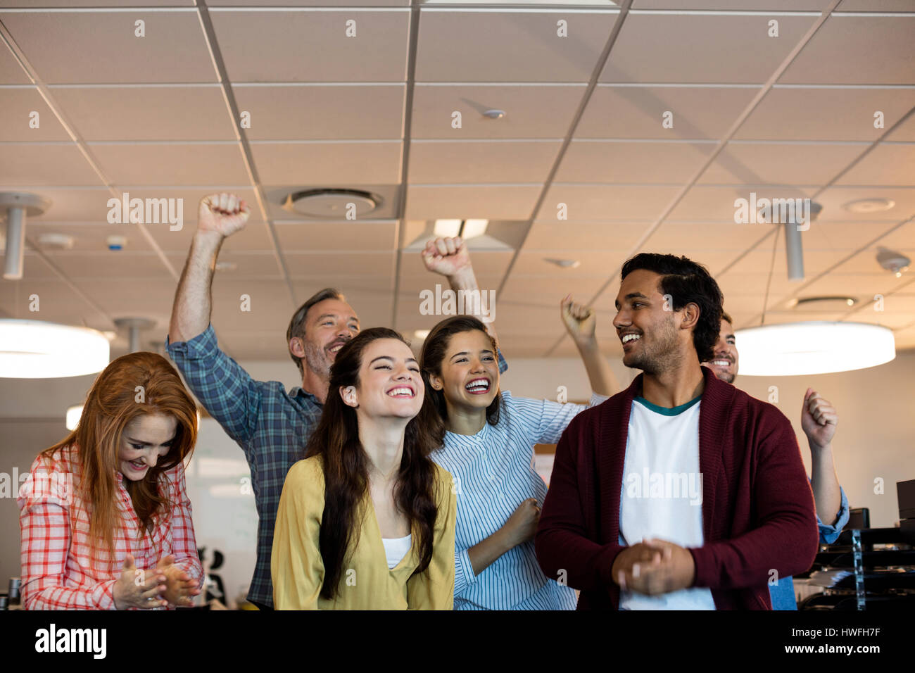Happy creative business team celebrating success in office Stock Photo ...