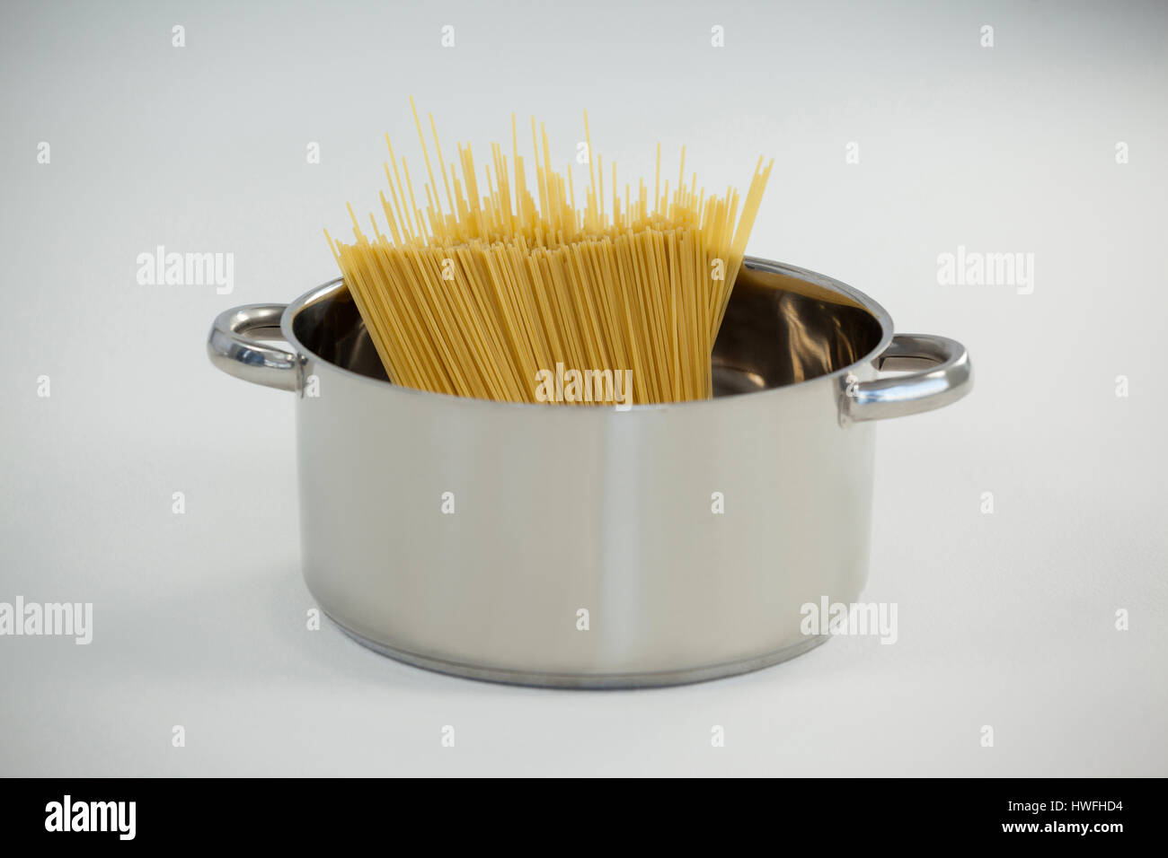 Spaghetti pasta in utensil on white background Stock Photo Alamy