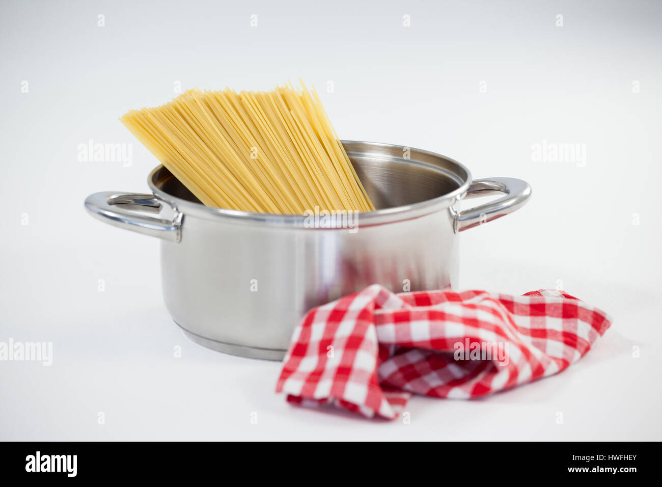 Spaghetti pasta in utensil on white background Stock Photo Alamy