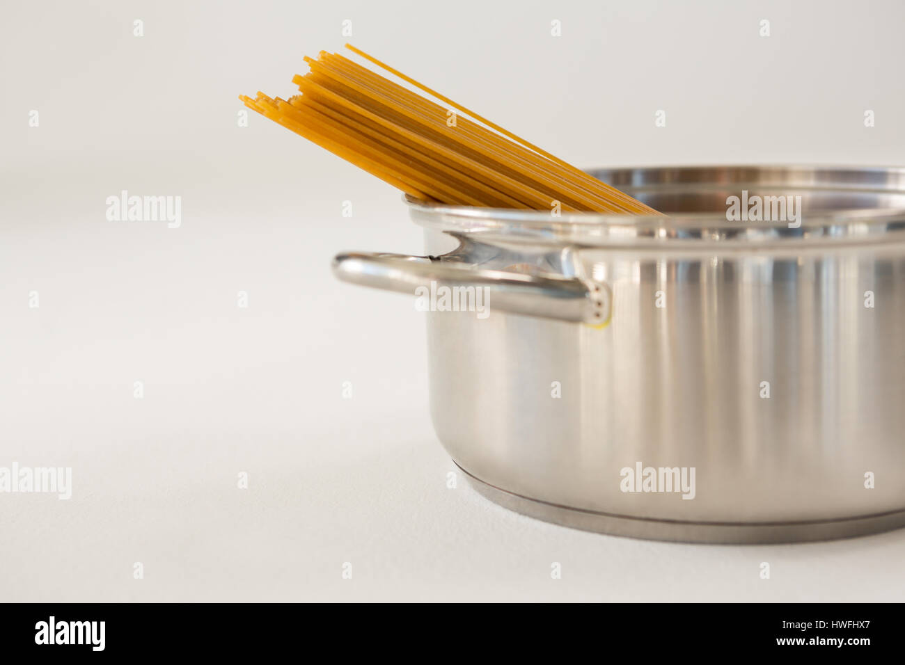 Spaghetti pasta in utensil on white background Stock Photo Alamy