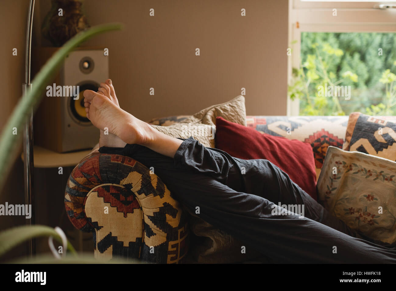 Woman lying on couch in hi-res stock photography and images - Alamy