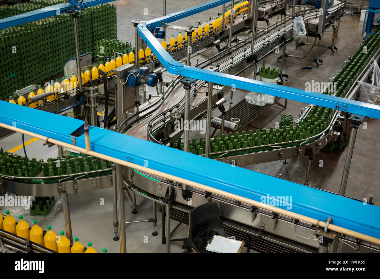 High angle view of cold drink bottles on production line in factory