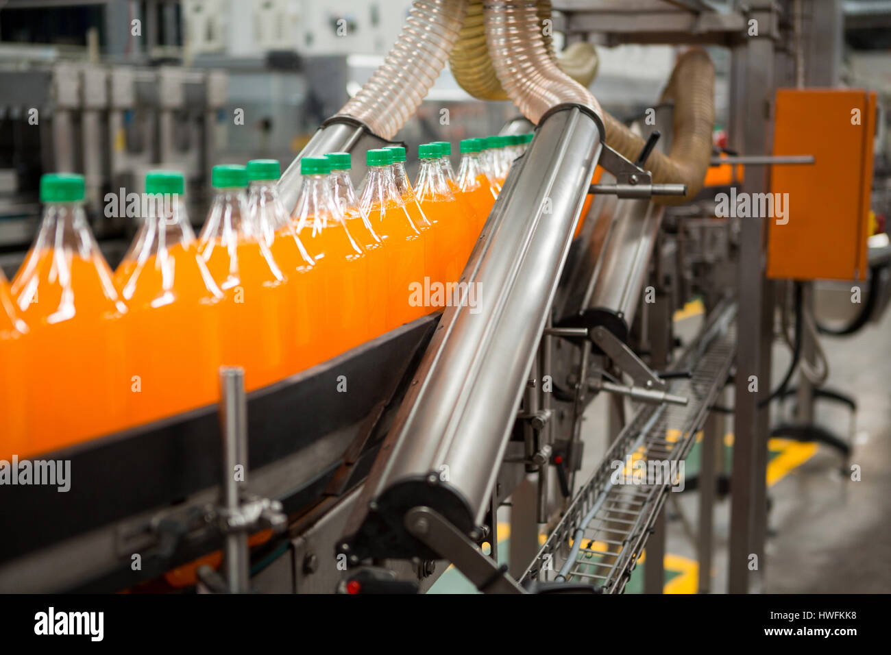 Packaging process of orange drink bottles in factory Stock Photo