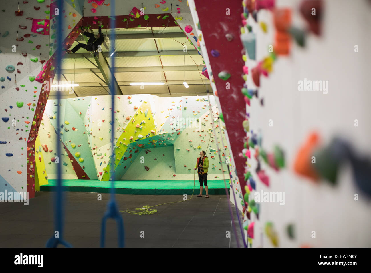 Man practicing rock climbing on artificial climbing wall in gym Stock Photo