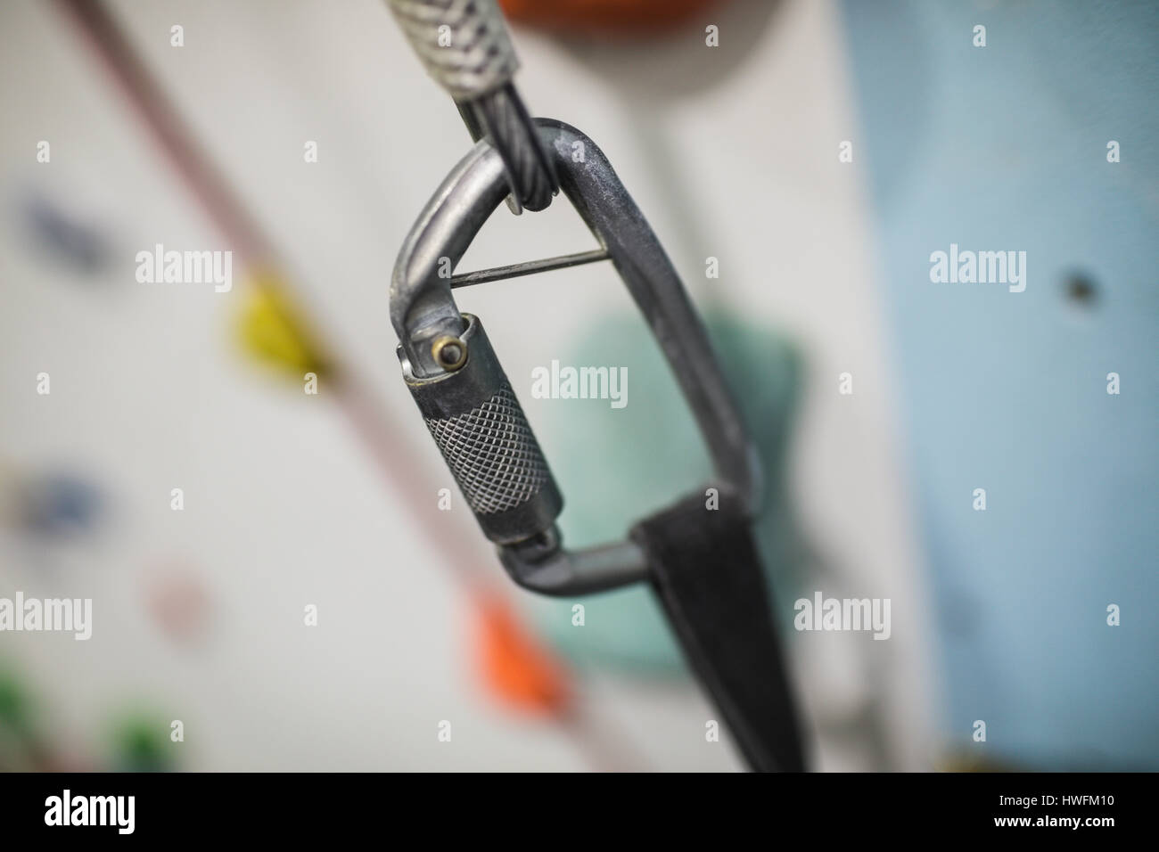 Close-up of carabiner hook on climbing artificial wall in gym Stock Photo