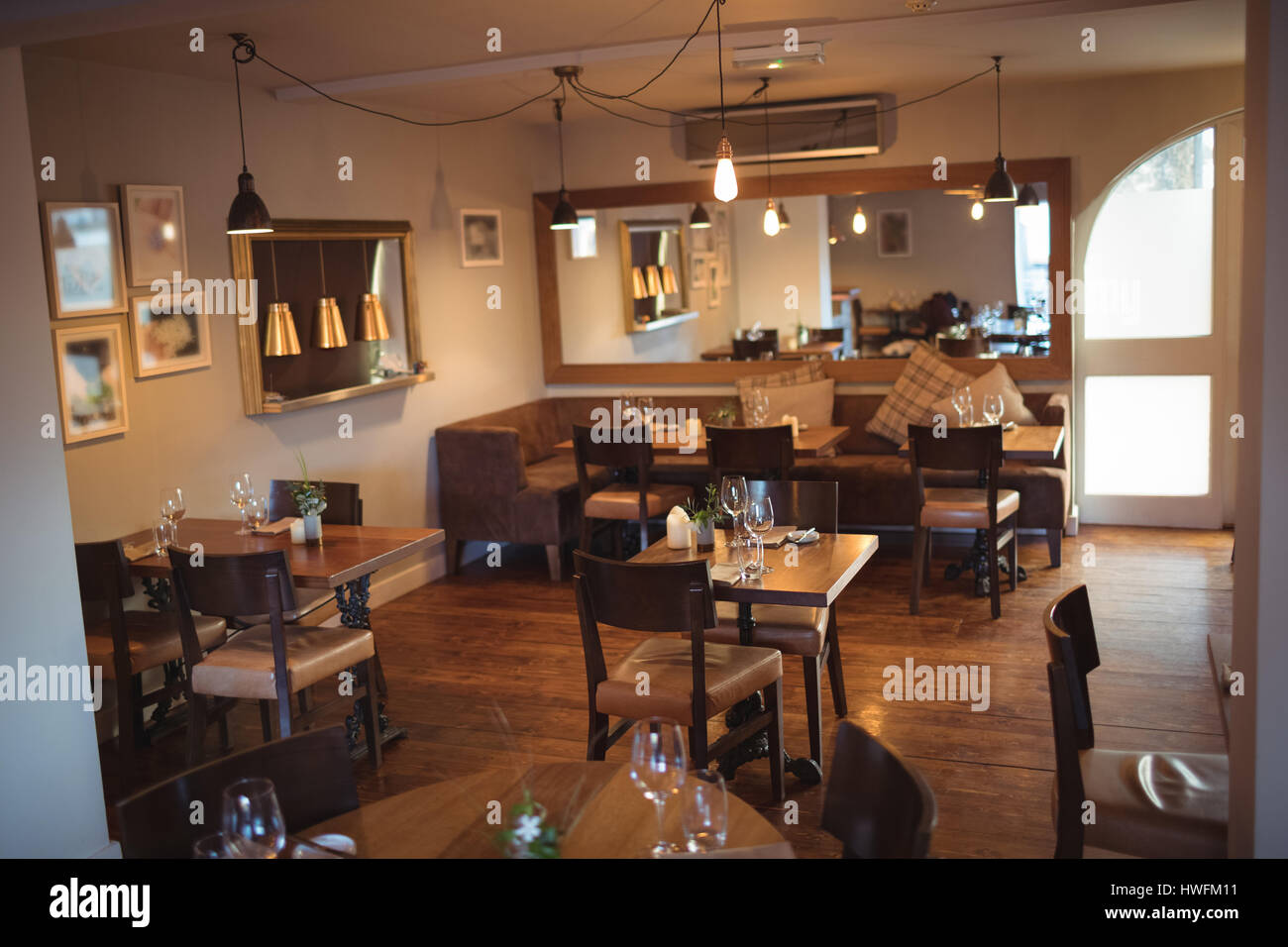 Tables and chairs arranged in empty modern coffee shop Stock Photo - Alamy