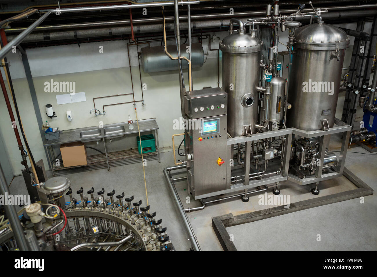 High angle view of manufacturing machinery in cold drink factory Stock