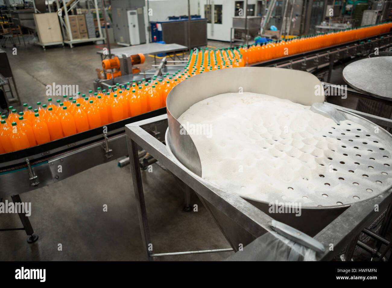 High angle view of orange cold drink bottles on production line in factory Stock Photo