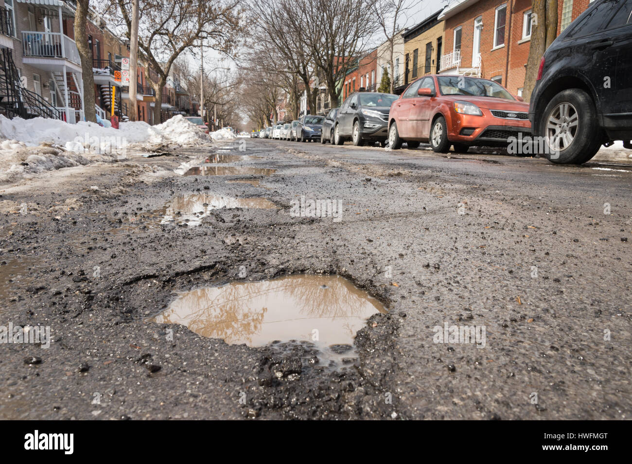 Montreal, Canada - 20 March 2017: Large pothole in the Plateau district Stock Photo