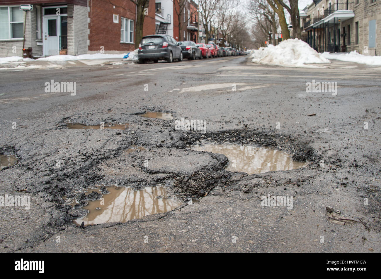 Montreal, Canada - 20 March 2017: Several large potholes on Bienville Street Stock Photo