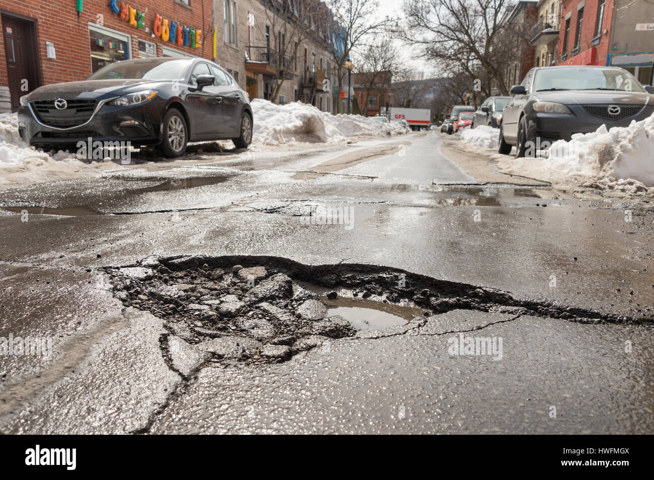 Montreal, Canada - 20 March 2017: Large pothole on East Duluth Avenue. Stock Photo