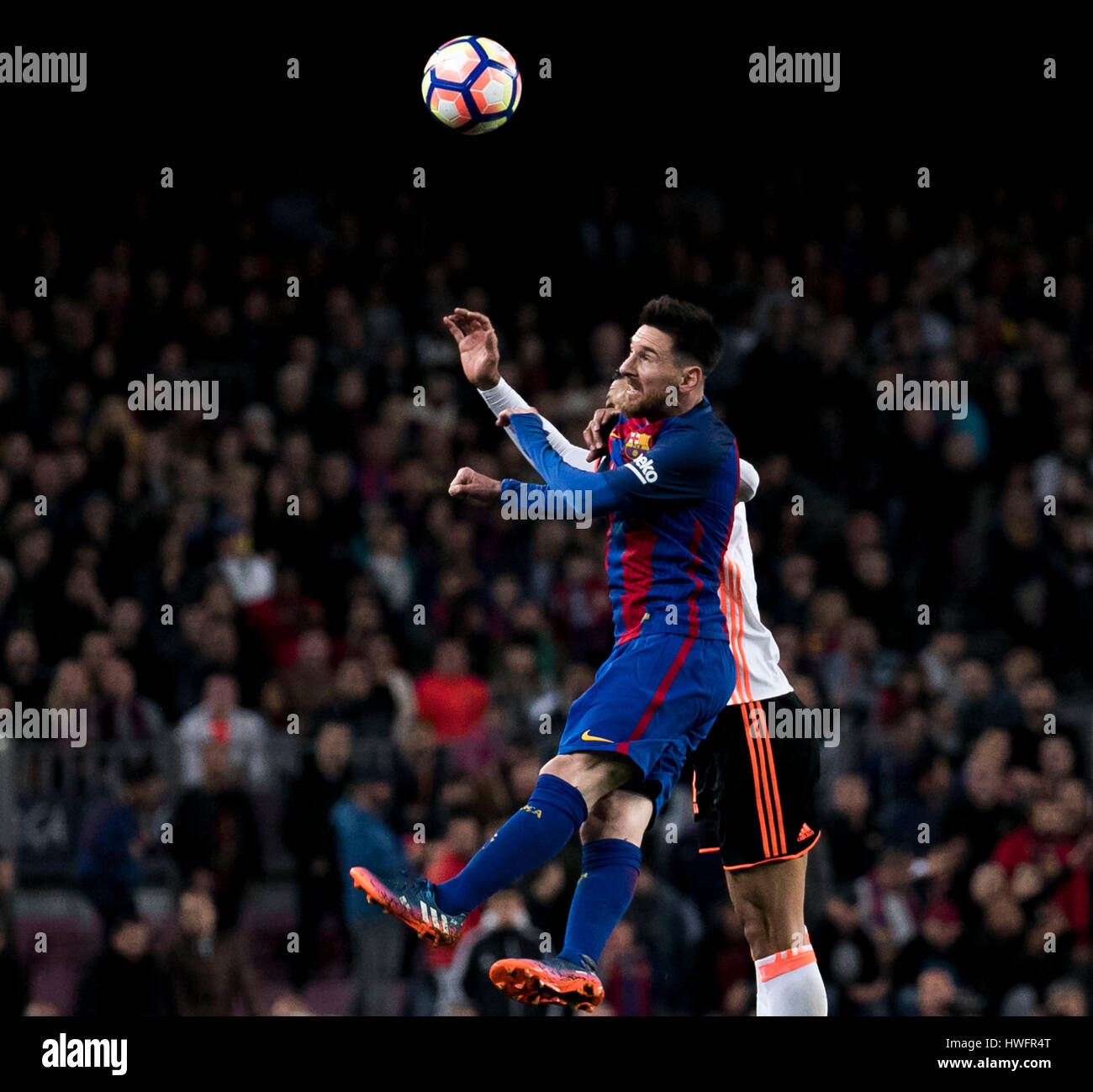 Camp Not Stadium, Barcelona, Spain. , . Messi jumps to stole an aerial ball  to Garay during a match of Santander League between FC Barcelona and  Valencia CF at Camp Nou Stadium,