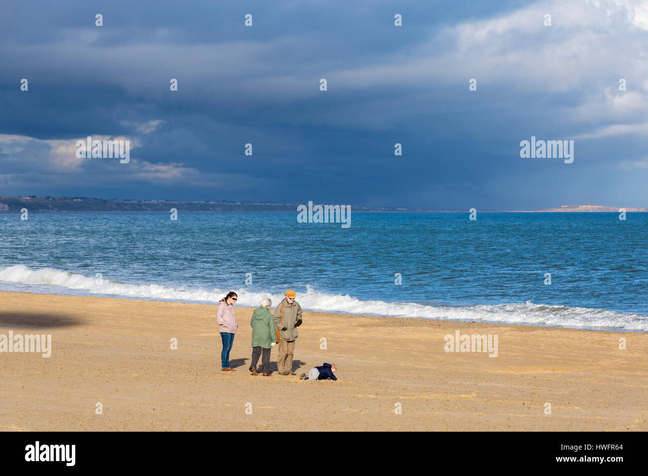 Poole, Dorset, UK. 20 March 2017. UK weather visitors enjoy the evening sunlight with stormy
