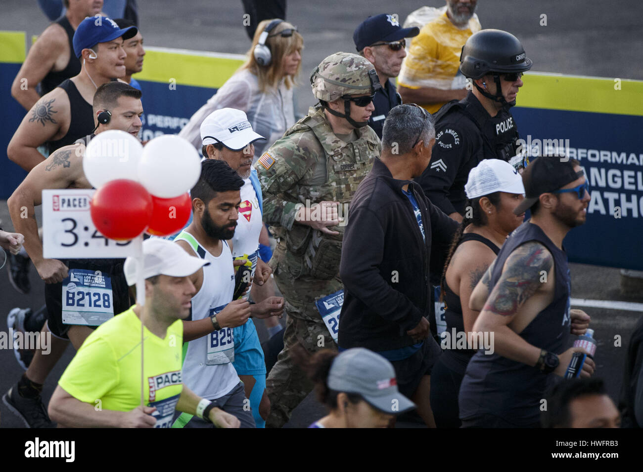 Los Angeles, CA, USA. 19th Mar, 2017. A soldier, LAPD Senior lead Officer Joe Cirrito, right, and other law enforcement officers run in full tactical gear to honor slain Whittier Police Department Officer Keith Boyer wear full tactical gear while running at the start of the 32nd annual Los Angeles Marathon at Dodger Stadium on Sunday morning, March 19, 2017 in Los Angeles, Calif. The 26.2-mile ''Stadium to the Sea'' route begins at Dodger Stadium and ends at Ocean and California avenues in Santa Monica. © 2017 Patrick T. Fallon Credit: Patrick Fallon/ZUMA Wire/Alamy Live News Stock Photo