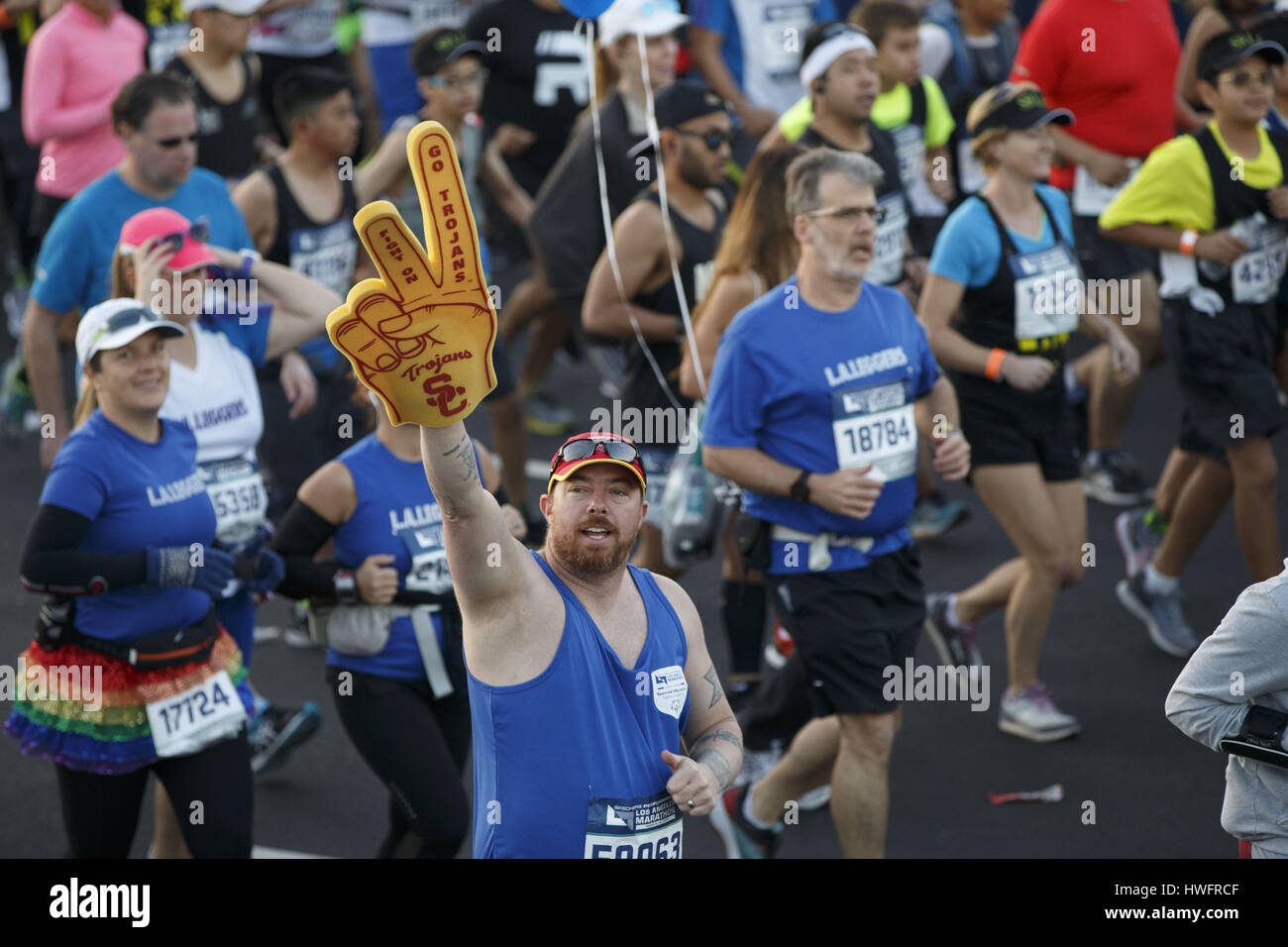 Los Angeles, CA, USA. 19th Mar, 2017. A runner carries a University of