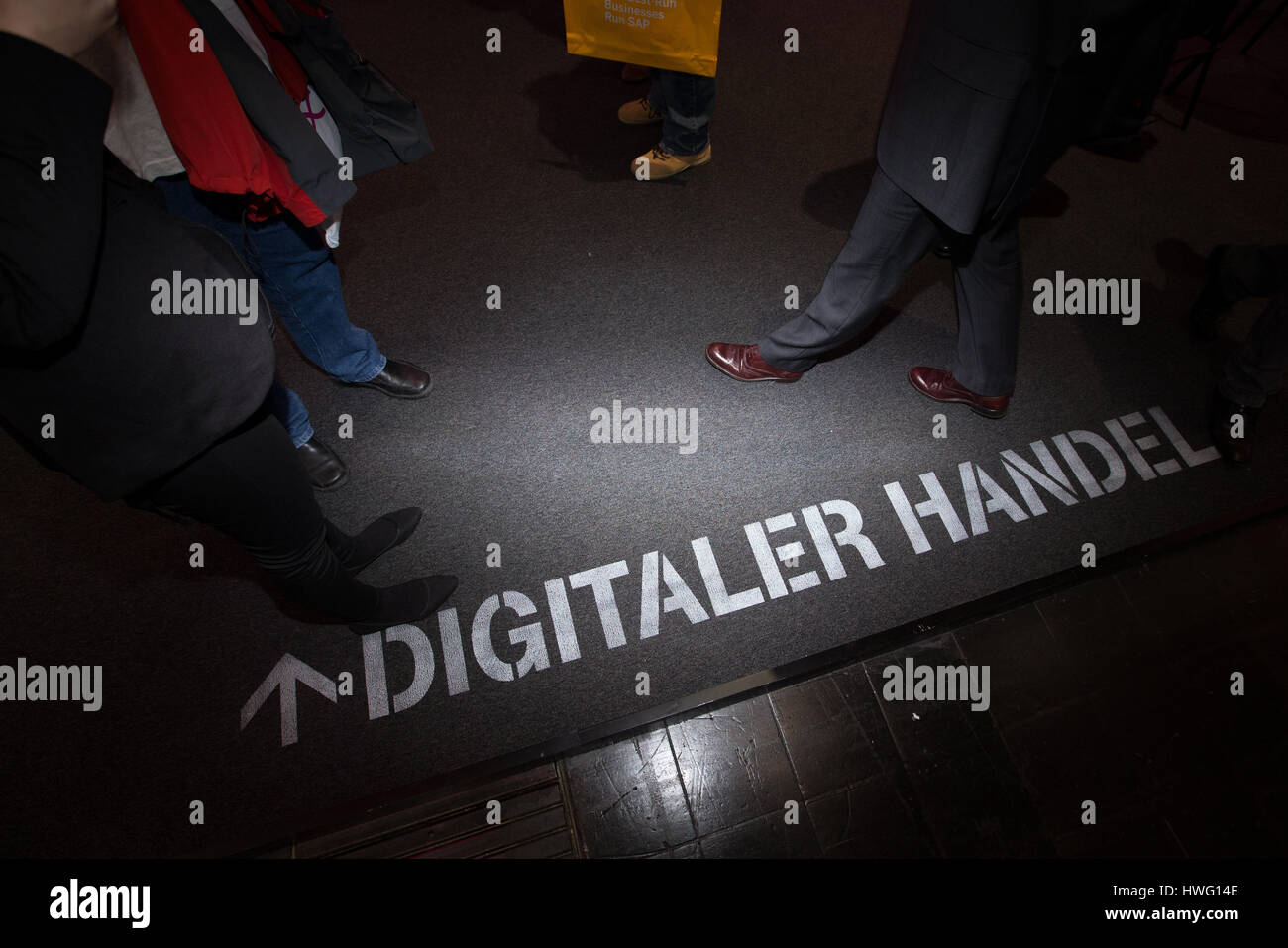 Hanover, Germany. 21st Mar, 2017. 'Digitaler Handel' (lit. 'Digital Trade') is written on the floor in order to advertise for the new services at the stand of the Telekom at the IT fair CeBIT in Hanover, Germany, 21 March 2017. The IT fair CeBIT wants to impress its expert audience with concrete application of new technology. The five day long trade fair (20 - 24 March) with more than 3000 exhibitors from 70 countries awaits approx. 200,000 visitors. The partner nation is Japan. Photo: Friso Gentsch/dpa/Alamy Live News Stock Photo