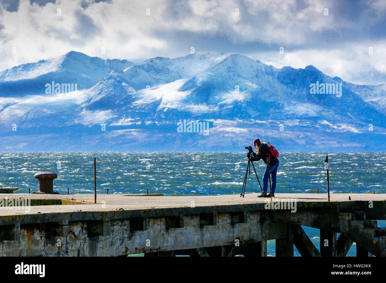 Portencross, Ayrshire, UK. 21st March 2017. Strong cold winds at Portencross castle on the Firth of Clyde and a heavy snow fall on Goatfell mountain on the Island of Arran, aren't enough to put off the hardiest of photographers. Credit: Findlay/Alamy Live News Stock Photo