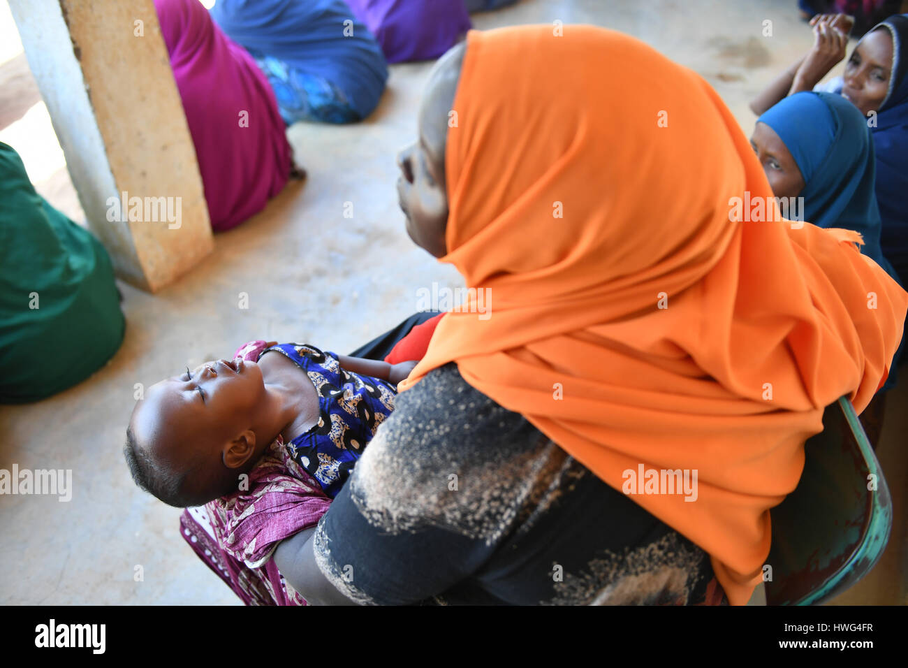 (170321) -- DOOLOW (SOMALIA), March 21, 2017 (Xinhua) -- A child sleeps in her mother's arms inside the IDP camp in Doolow, a border town with Ethiopia, in Somalia, on March 20, 2017. One out of seven Somali children dies before its fifth birthday, and acute malnutrition weakens the immune system, which makes affected children more susceptible to disease such as measles, a UN spokesman told reporters earlier this month. In Somalia, drought conditions are threatening an already fragile population battered by decades of conflict. Almost half the population are facing acute food insecurity and in Stock Photo