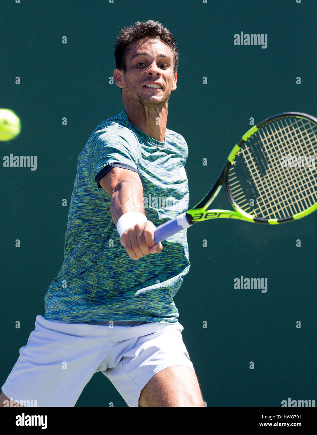 Key Biscayne, Florida, USA. 21st Mar, 2017. Rogerio Dutra Silva, from Brazil, plays a backhand against Christian Harrison, of the United States, at the 2017 Miami Open presented by Itau professional tennis tournament, played at Crandon Park Tennis Center in Key Biscayne, Florida, USA. Mario Houben/CSM/Alamy Live News Stock Photo