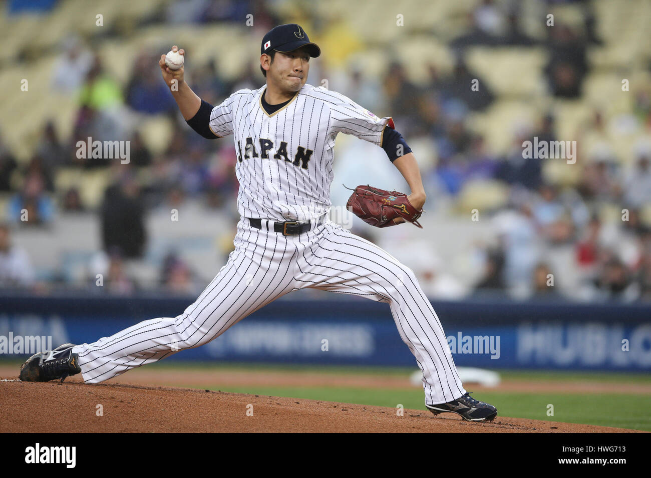Los Angeles, CA, USA. 21st Mar, 2017. Japan pitcher Tomoyuki Sugano #11 makes the start for Japan in the game between the the United States and Japan, World Baseball Classic Semi-Finals, Dodger Stadium in Los Angeles, CA. Peter Joneleit /CSM/Alamy Live News Stock Photo