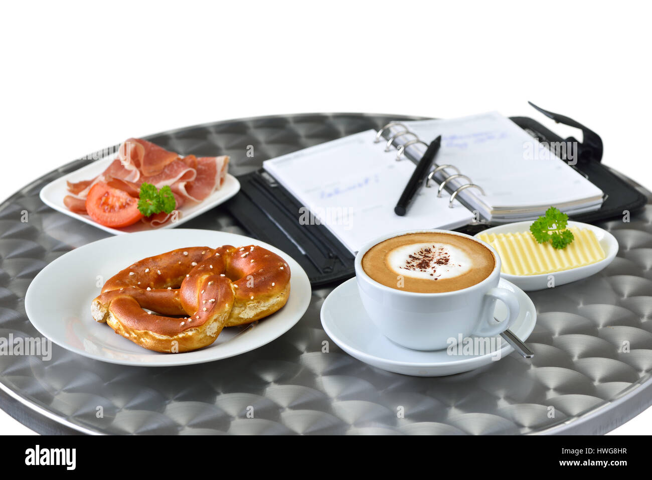 Business snack with a ham sandwich and a cup of cappuccino; a personal organizer in the background Stock Photo