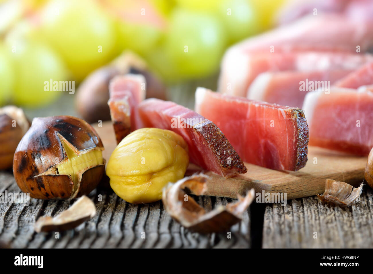 Roasted chestnuts with South Tyrolean red wine on an old wooden table Stock Photo