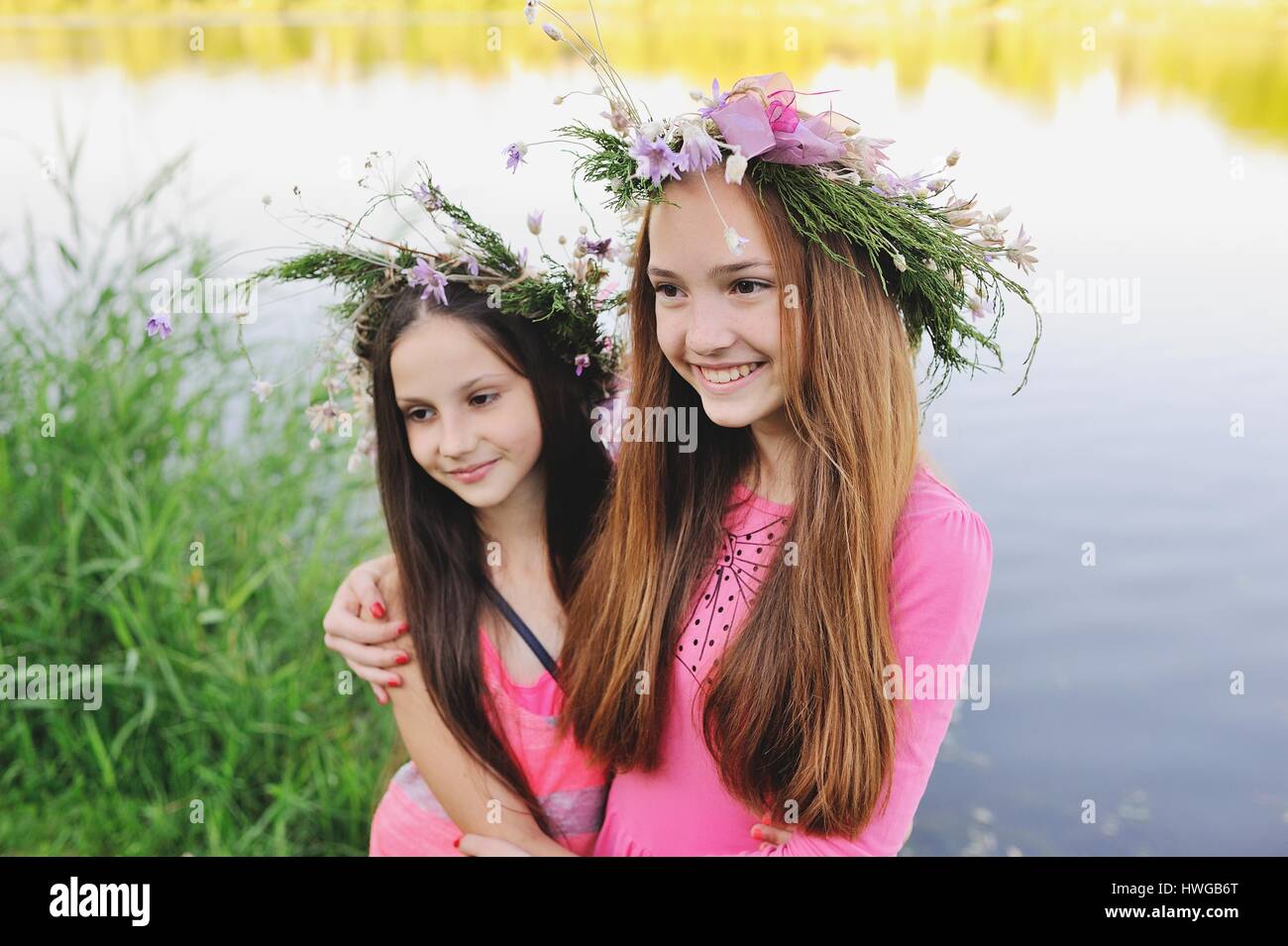 Two young girls in wreaths of wild flowers Stock Photo - Alamy