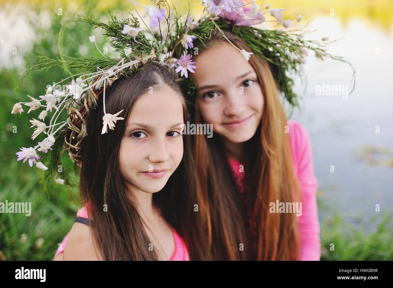 Two young girls in wreaths of wild flowers Stock Photo - Alamy
