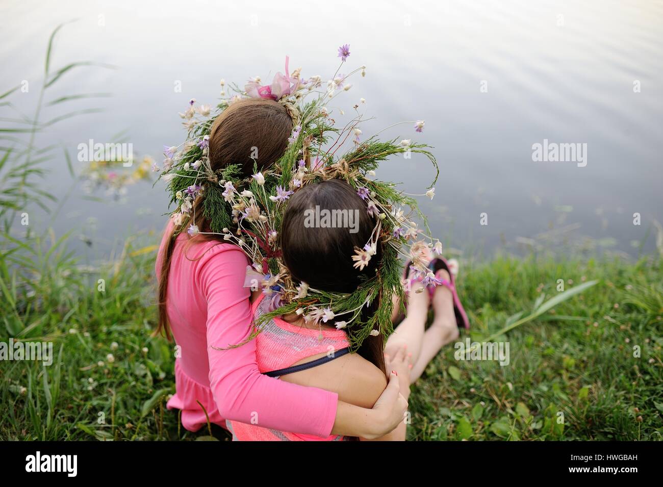 Two young girls in wreaths of wild flowers Stock Photo - Alamy