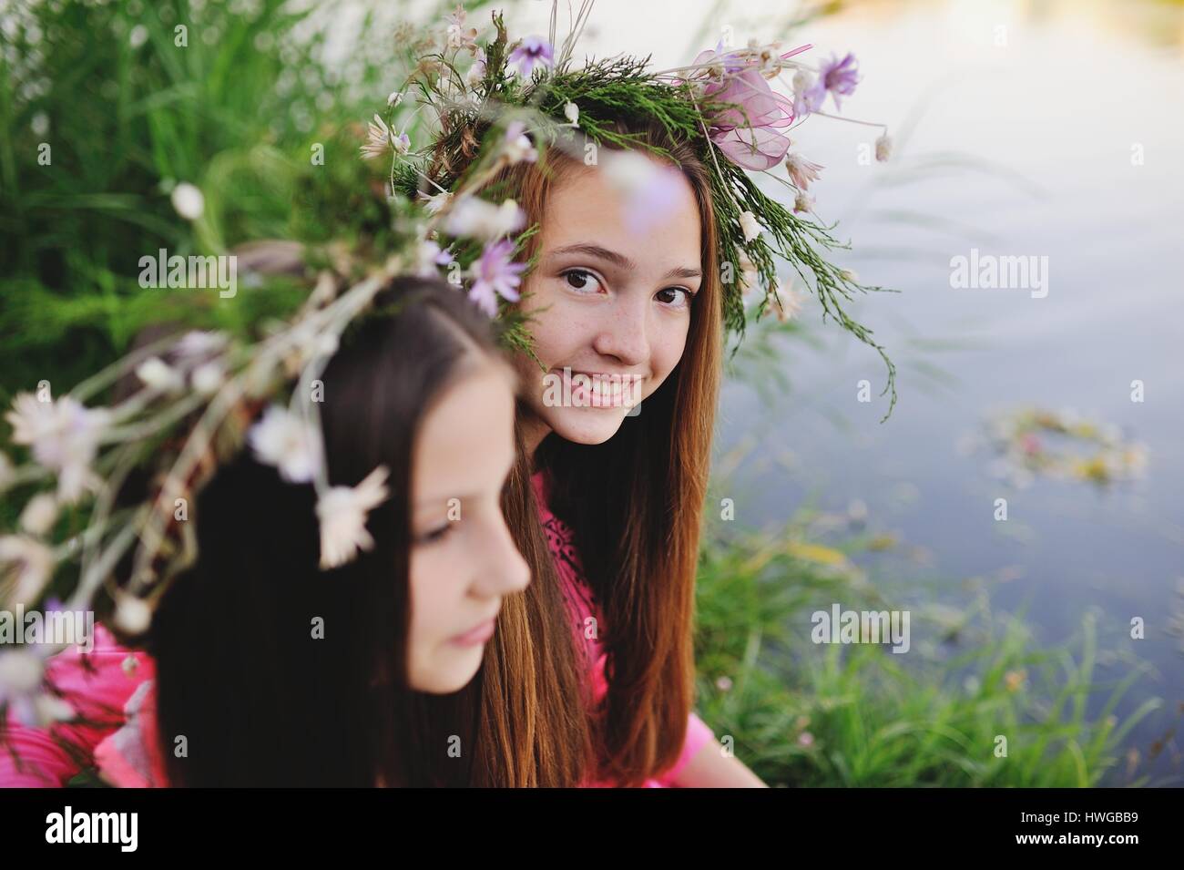 Two young girls in wreaths of wild flowers Stock Photo - Alamy