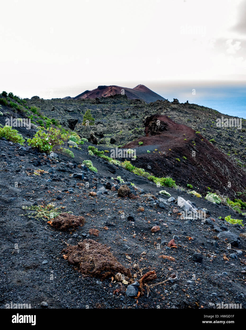 Cumbre Vieja, Fuencaliente. La Palma.  A view along the volcano's winding ridge and geological land formation. Very little vegetation grows in the lava rock of Cumbre Vieja region.  It's a bright day with fast moving clouds. Stock Photo