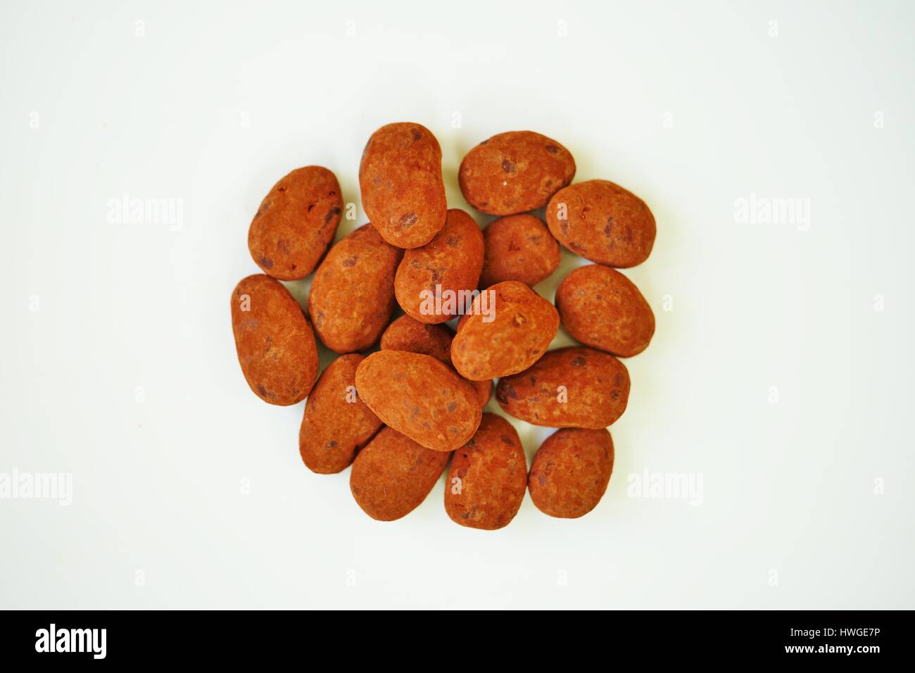 Whole almonds covered with French dark chocolate and cocoa powder on a