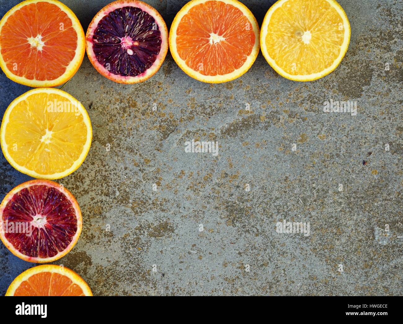 Colorful oranges, blood oranges, and cara cara oranges cut in half on a